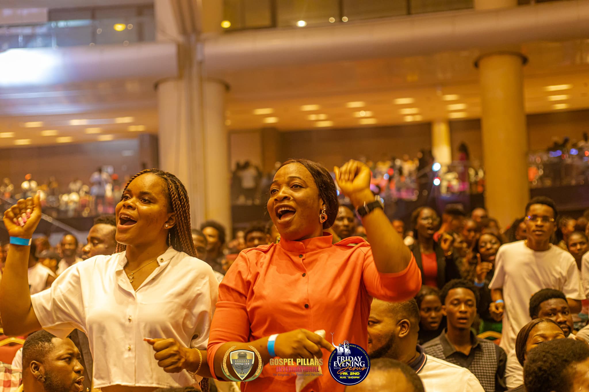 Worshippers singing with hands raised at Eko Convention Centre, Lagos