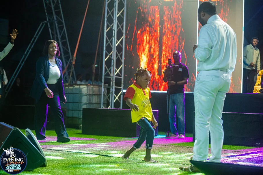 A young girl walking on stage after being prayed for