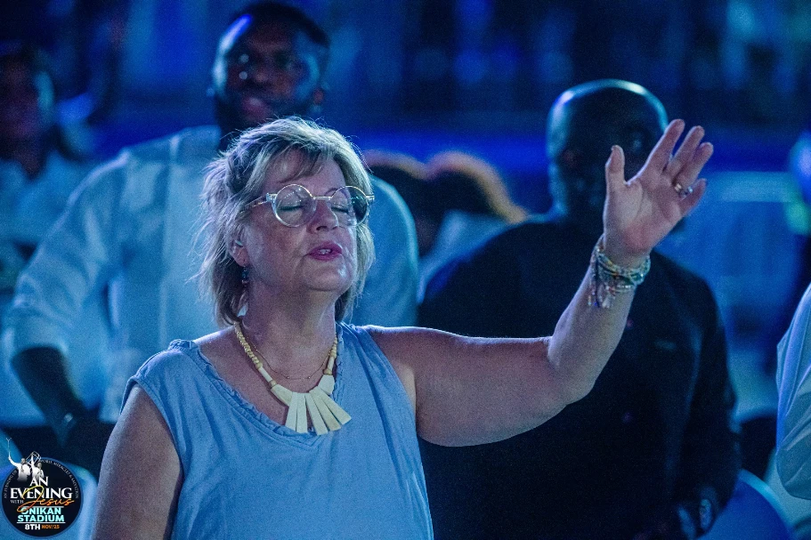 A diverse multi-racial crowd worshipping at An Evening With Jesus