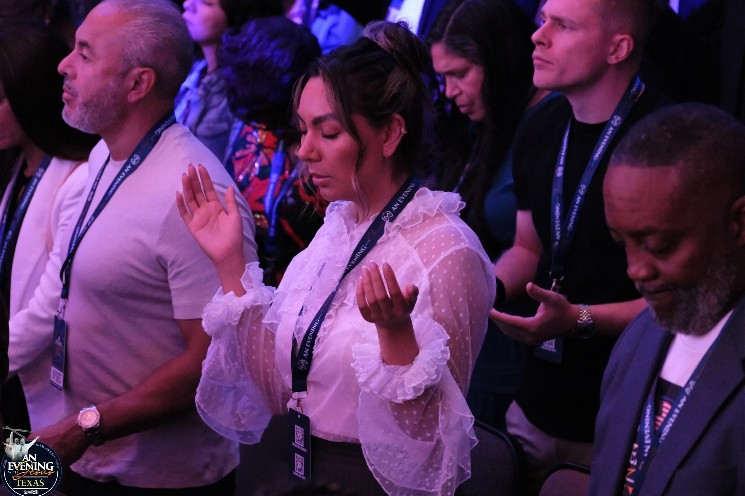 Attendees praying together at An Evening With Jesus, Texas