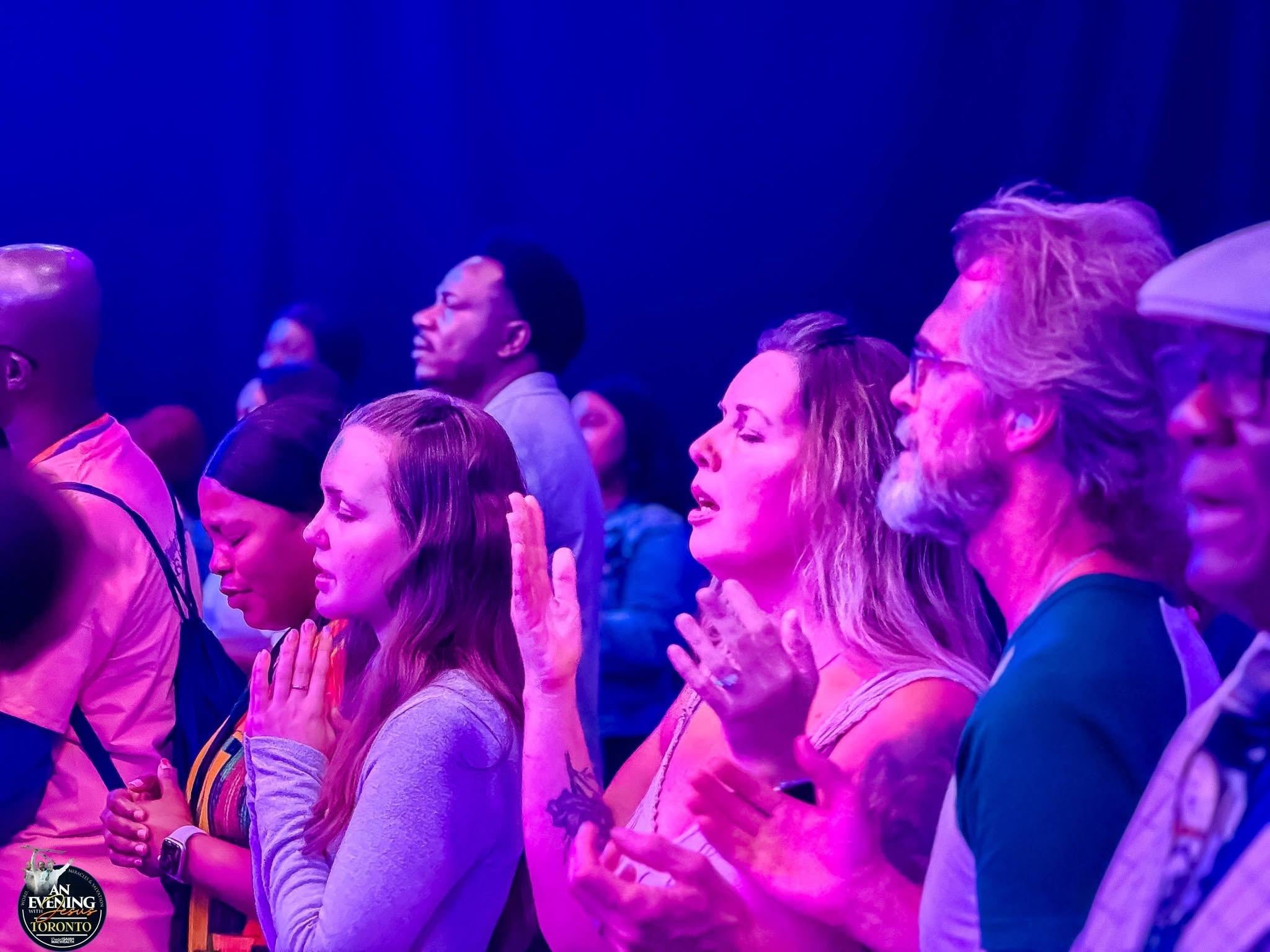 Worshippers praying at An Evening With Jesus, Toronto